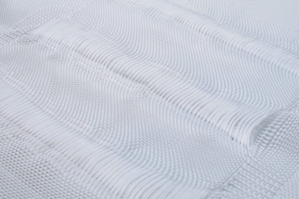 Close-up view of a geotextile mattress showcasing its woven texture, made from synthetic fibers like polypropylene. The intricate patterns demonstrate the material's permeability and structural integrity, ideal for civil engineering applications. This image highlights the quality and design of the geotextile mattress, essential for effective erosion control and site stabilization.
