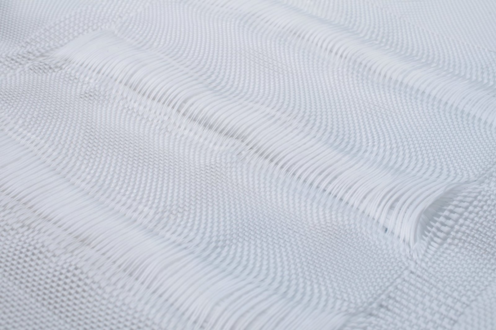 Close-up view of a geotextile mattress showcasing its woven texture, made from synthetic fibers like polypropylene. The intricate patterns demonstrate the material's permeability and structural integrity, ideal for civil engineering applications. This image highlights the quality and design of the geotextile mattress, essential for effective erosion control and site stabilization.