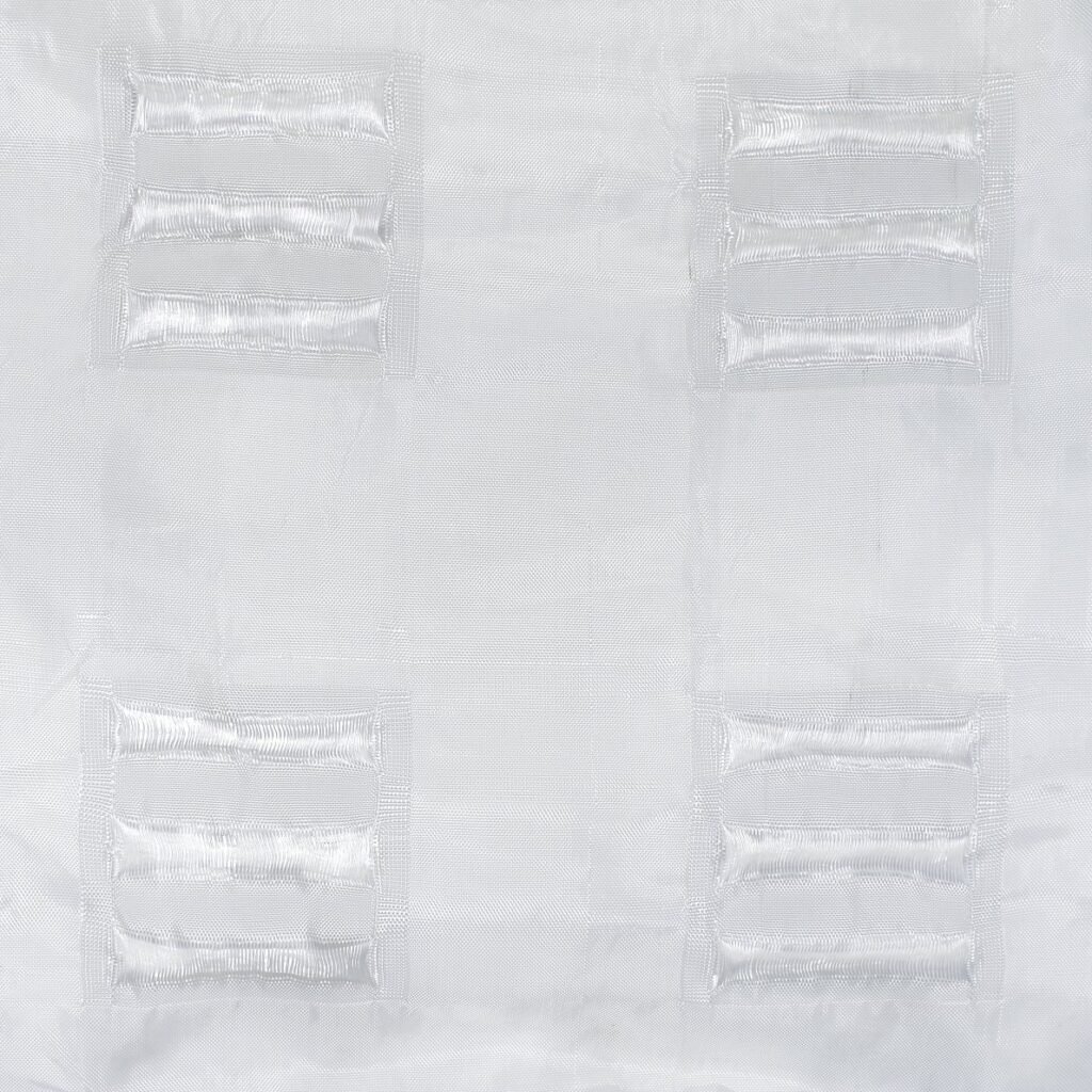 Close-up view of a geotextile mattress showcasing its texture and structural features. The image highlights the woven synthetic fibers and connection points on the surface, illustrating strong, durable material characteristics. This geotextile mattress is designed for environmental protection and erosion control in civil engineering applications.