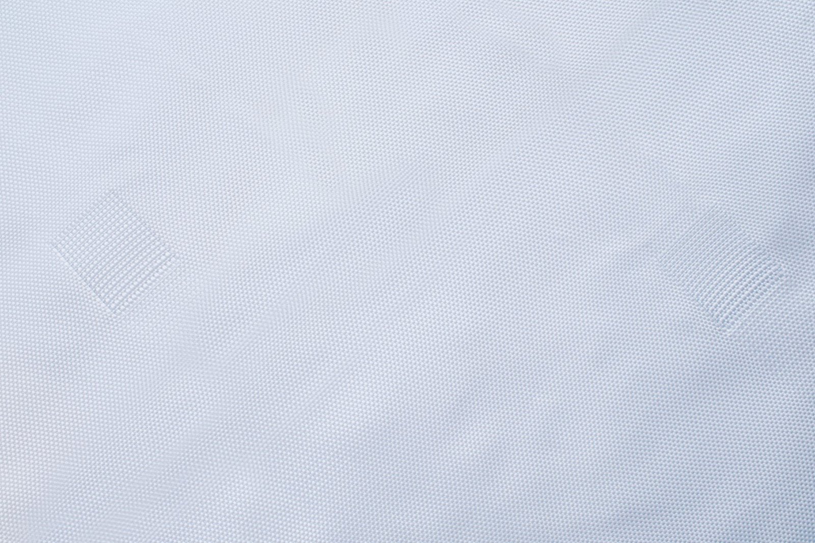 Close-up of a geotextile mattress showcasing a woven texture, highlighting the synthetic fiber composition for enhanced strength and durability. The fabric appears soft yet sturdy, ideal for filtration and stabilization in civil engineering projects.